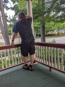 man standing on a porch